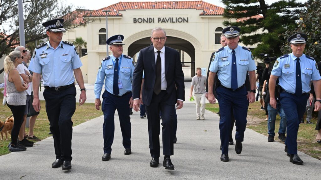 Australian Prime Minister Anthony Albanese, center, visits the Bondi Pavilion where he laid flowers at Bondi Beach in Sydney, Monday, Dec. 15, 2025, a day after a shooting.
