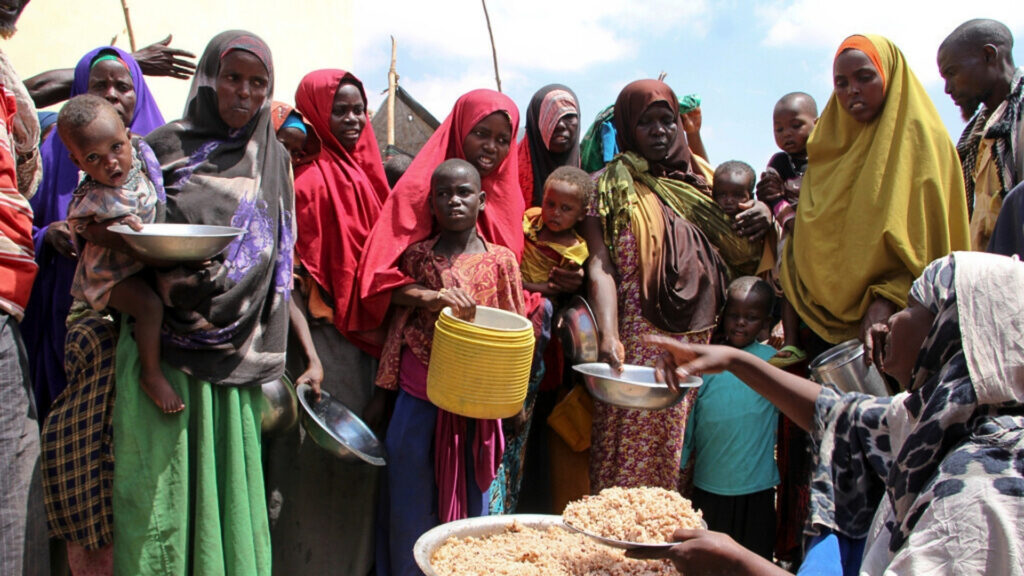 FILE - Newly arrived Somalis, displaced by a drought, receive food distributions at makeshift camps in the Tabelaha area on the outskirts of Mogadishu, Somalia on March 30, 2017.