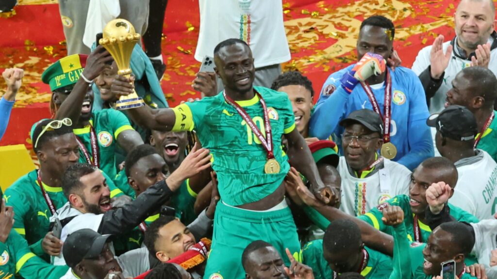 FILE - Senegal's Sadio Mane holds the trophy aloft as he celebrates with teammates after winning the Africa Cup of Nations final soccer match between Senegal and Morocco in Rabat, Morocco, Sunday, Jan. 18, 2026.