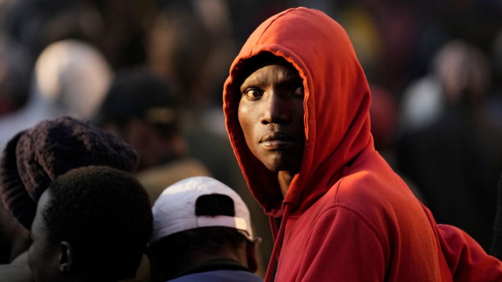 South Africa anti-migrant violence: Ghanaians petition ICC over attacks on foreigners A Malawian migrant stands in a queue ahead deportation at a temporary centre in Durban, South Africa, Friday, June 19, 2026.